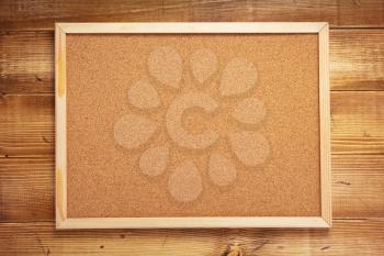 cork board on wooden wall background texture