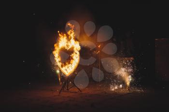 Heart from fire and fireworks.
