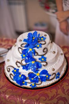 Beautiful festive pie with a pattern from dark blue flowers.