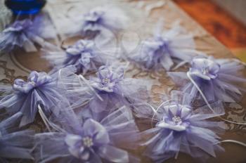 Violet bows lie on a table.
