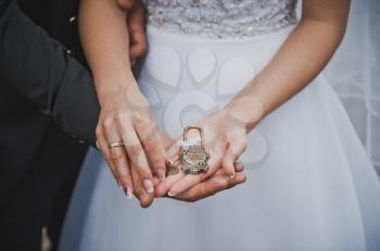 The lock in hands of the newly-married couple.
