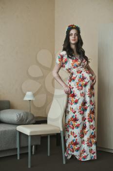 The girl during pregnancy in a beautiful dress.