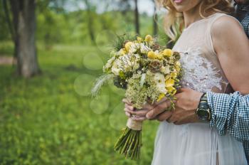 Bunch of flowers in hands of the girl.