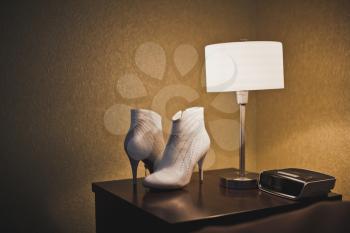 Lamp and shoes on a table.