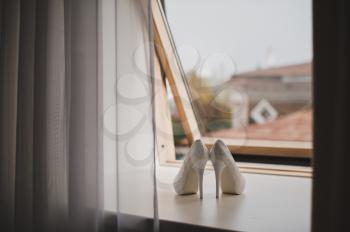 White shoes on the windowsill.