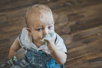 Portrait of a baby smeared with cake.