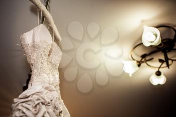 Wedding dress on a hanger before ceremony.