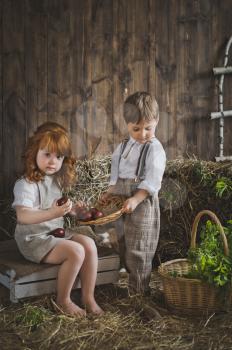 Children play with Easter eggs in the barn.
