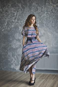 Portrait of a girl in a long striped dress.