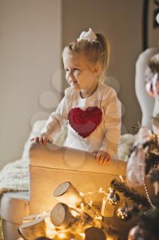 Portrait of baby in Christmas decorations.