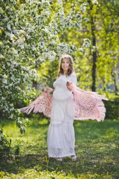 Pregnant woman in white dress with a beautiful pink shawl.
