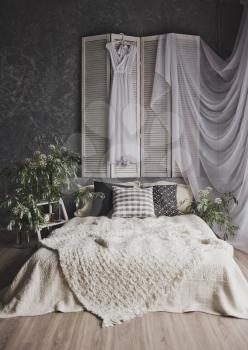White beige decoration in photo Studio, with the bed by the window.