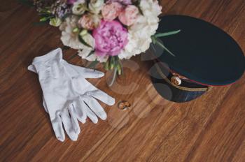 Festive white gloves about a bouquet of flowers.