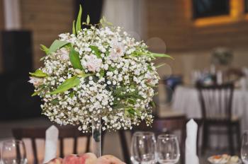 A bouquet of flowers as a table decoration.