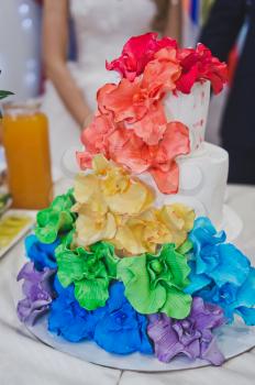 Cake decorated with flowers of all colors of the rainbow.