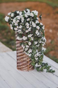 Bacopa is a common blooming bouquets in a wicker vase.