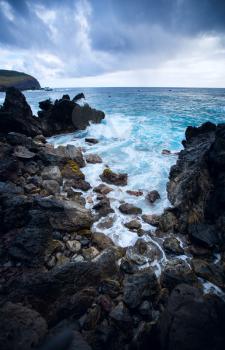 Easter Island rocky coast. The waves of the Pacific Ocean