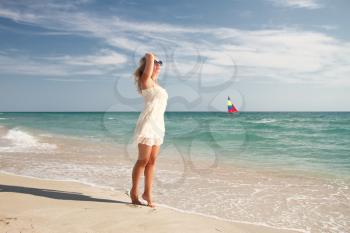 Bride walking along the beach near the ocean