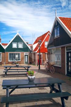 Vintage Dutch town of Volendam European evening. Retro style. houses and bikes on the street in the summer