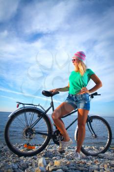 girl on a bicycle near the sea. Photo-style pin-up