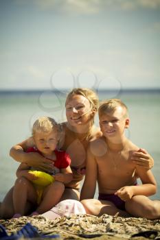 Mother with the children in the sea. summer holiday by the ocean. Lifestyle