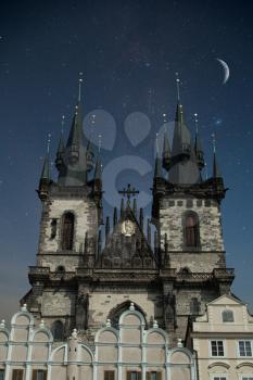 Prague Old town square, Tyn Cathedral. under sunlight. At night the stars shine and the moon.