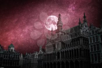 Grand Place - the historic square in the center of Brussels.The stars and the moon shine at night.