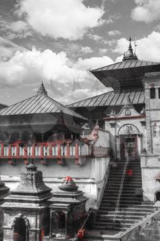 black and red and white photo. Votive temples and shrines in a row at Pashupatinath Temple, Kathmandu, Nepal.