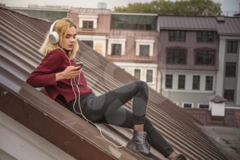 girl on the roof listening to music