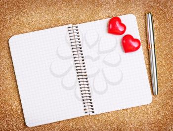 red hearts and note book on a table
