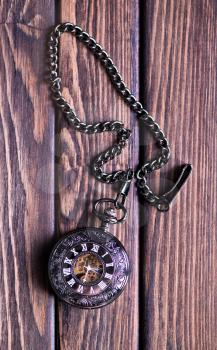 Vintage pocket watch and hour glass or sand timer, symbols of time with copy space
