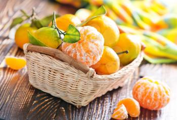 tangerines in basket and on a table