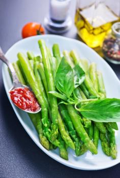 green asparagus, fresh asparagus on plate and on a table