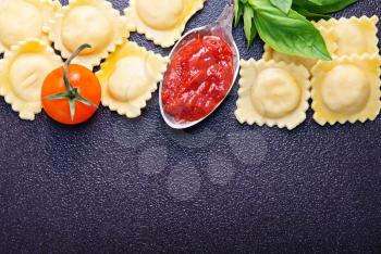 raw ravioli, tomato pasta and fresh basil