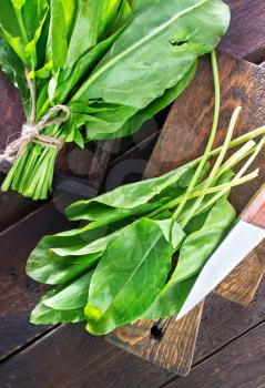 fresh sorrel on the wooden board and on a table