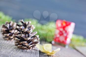 pinecones and christmas candle on a table