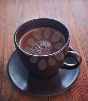 cocoa in brown cup and on a table