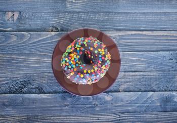 chocolate donut on plate and on a table