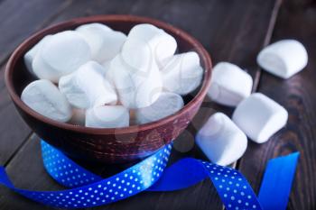 white marshmallows in the bowl and on a table