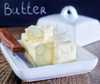 butter on white plate and on a table