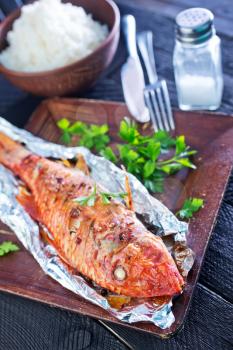 baked fish in the foil and on a table