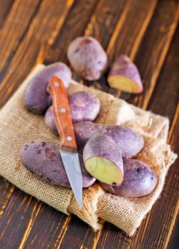 raw potato, potato on the wooden table