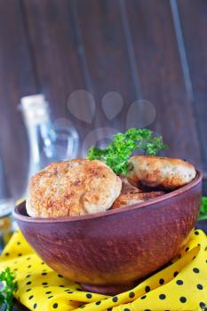 cutlets in bowl and on a table
