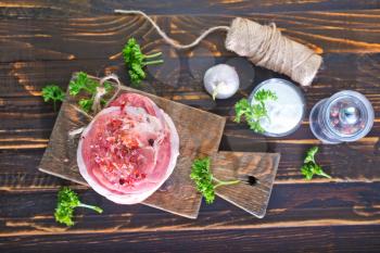 raw meat with salt and spice on the wooden board
