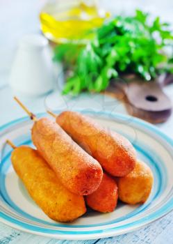 corndogs on plate and on a table