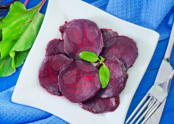 boiled beet on plate and on a table