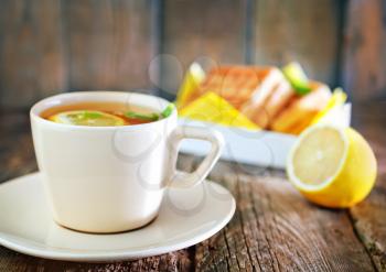 tea with lemon and sweet waffle on a table