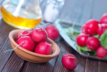 fresh radish in bowl and on a table