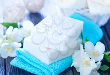 white soap and towels on a table