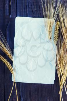 wheat and paper on the wooden background